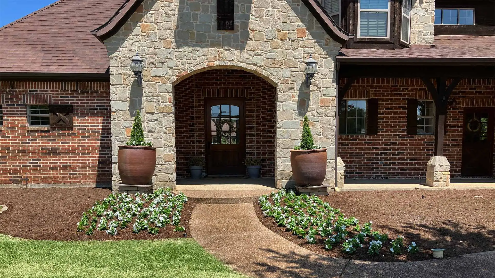 Front of a home with a landscape bed installed in Denton, TX.