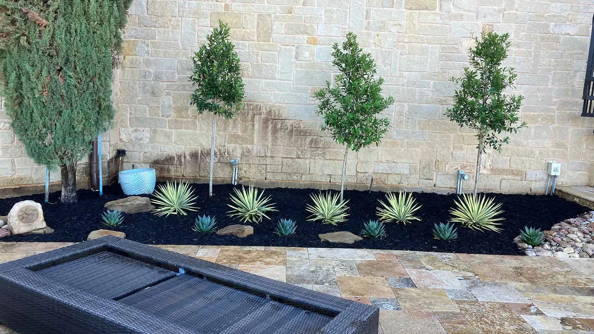 Small landscape bed installed beside a pool deck in Northlake, TX.