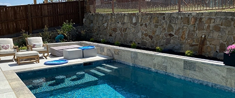 Pool with landscape bed installed in Argyle, TX.