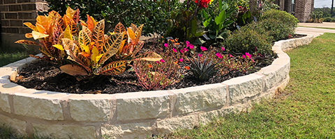 Retaining wall beside annuals in Northlake, TX.