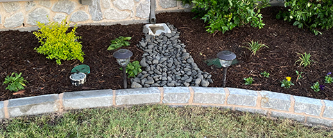Small drainage in landscape bed in Denton, TX.