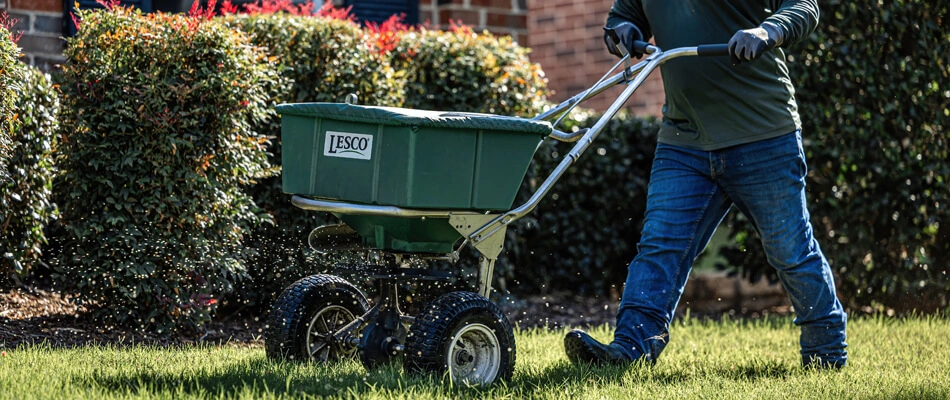 A technician applying weed control to a lawn in Northlake, TX.
